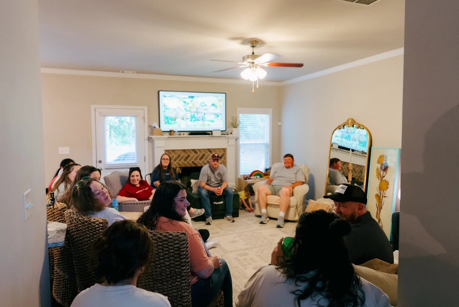 A group gathered in a living room talking together