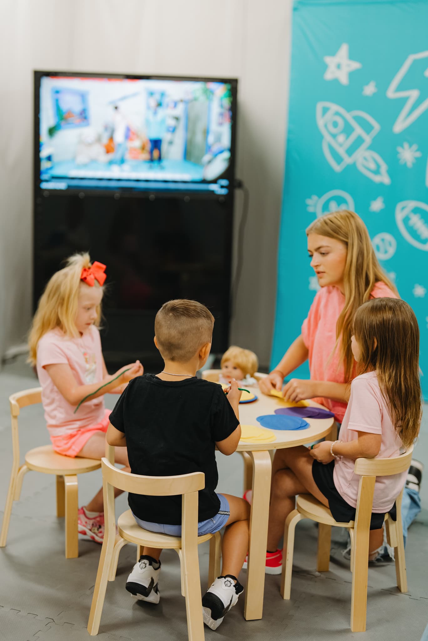 Kids doing a craft activity at a table in Brighthouse Kids