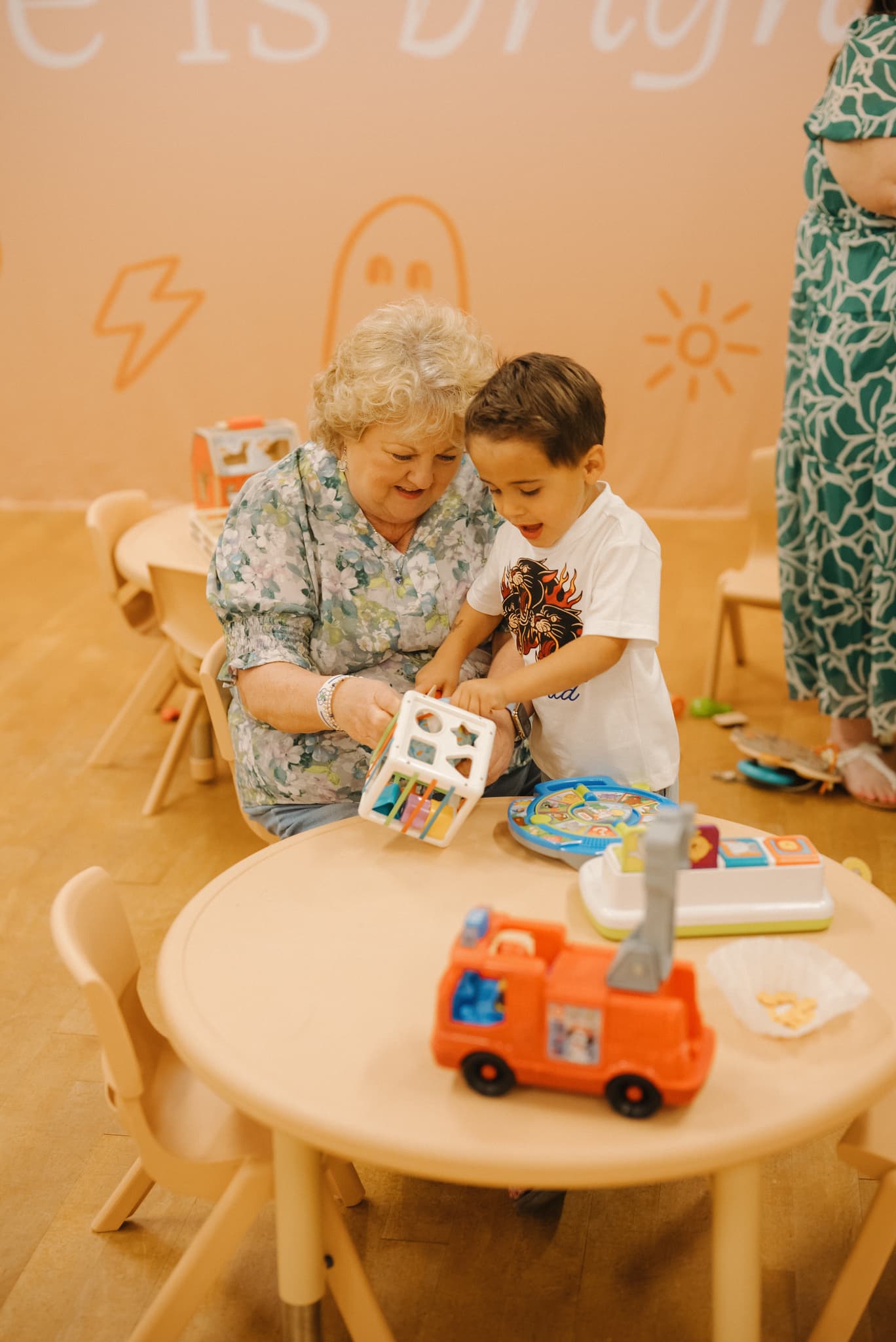 A caring Brighthouse Kids volunteer playing with a child