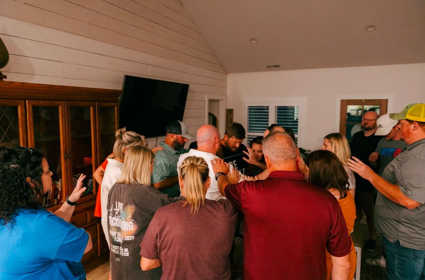 Pastors Derek and Nikki Dale gathered with friends and prayer partners, laying hands in prayer over Brighthouse Church