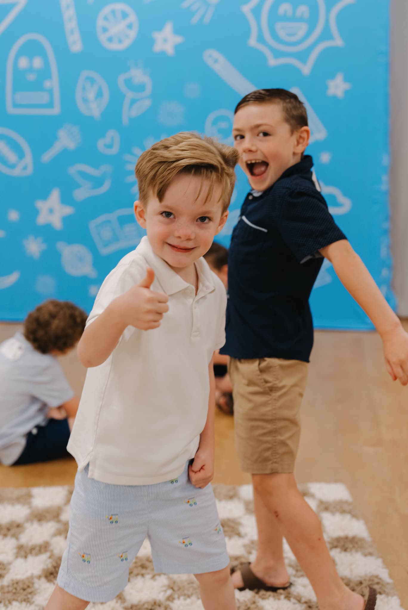 Two excited kids in the bright Brighthouse Kids environment