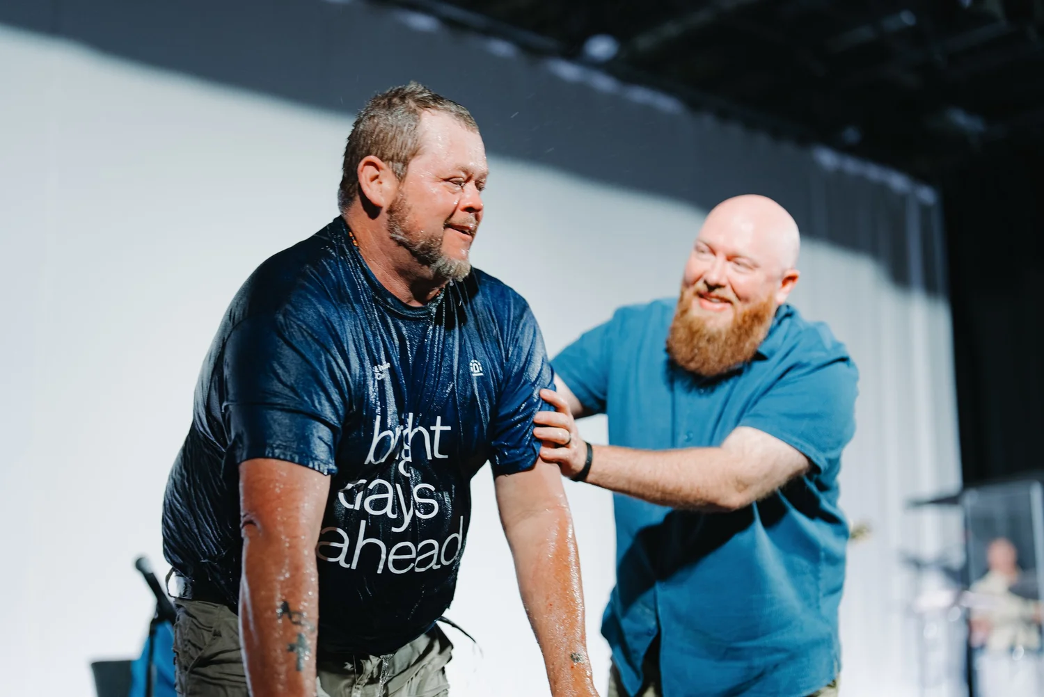 A man being baptized and celebrating his new life in Christ at Brighthouse Church